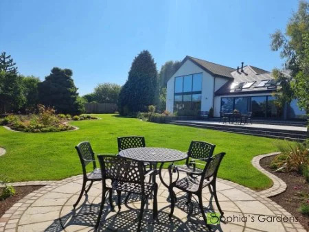 From a circular patio to beautiful curvaceous lawns to the rear of a contemporary house and garden